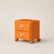 Orange two-drawer filing cabinet on wheels with silver handles against a beige background