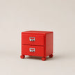 Red two-drawer rolling cabinet on a beige background