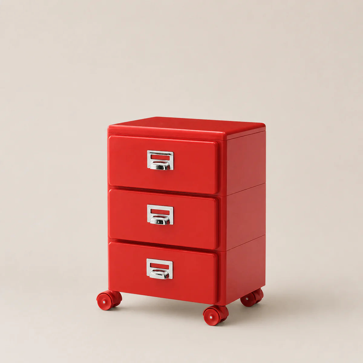 Red three-drawer filing cabinet with wheels on a beige background