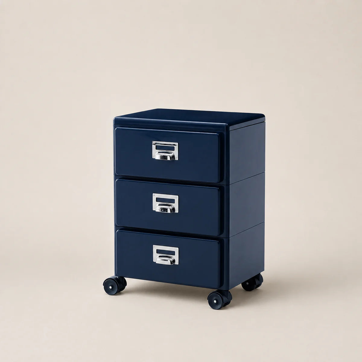 Navy blue three-drawer filing cabinet on wheels with metallic handles against a beige background