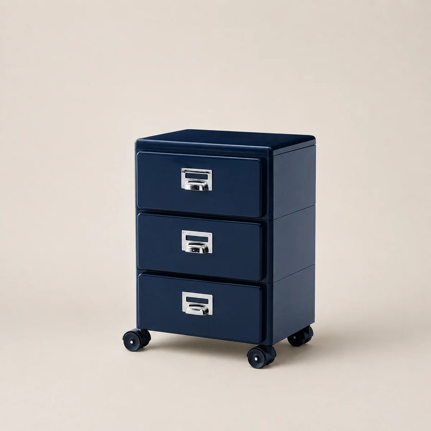 Navy blue three-drawer filing cabinet on wheels with metallic handles against a beige background