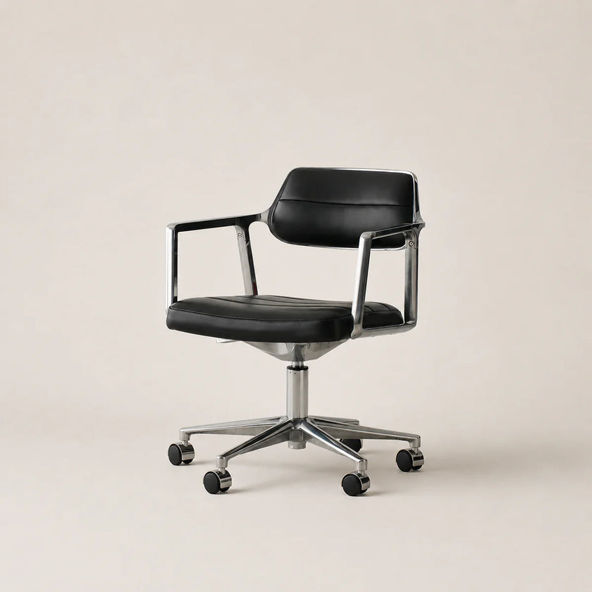 Black office chair with chrome base on a beige background
