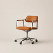 Brown office chair with metal frame on a beige background