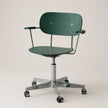 A modern dark green office chair with a curved backrest, armrests, and a chrome five-star base with casters, shown against a neutral light beige background.