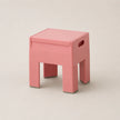 Pink stool on a beige background