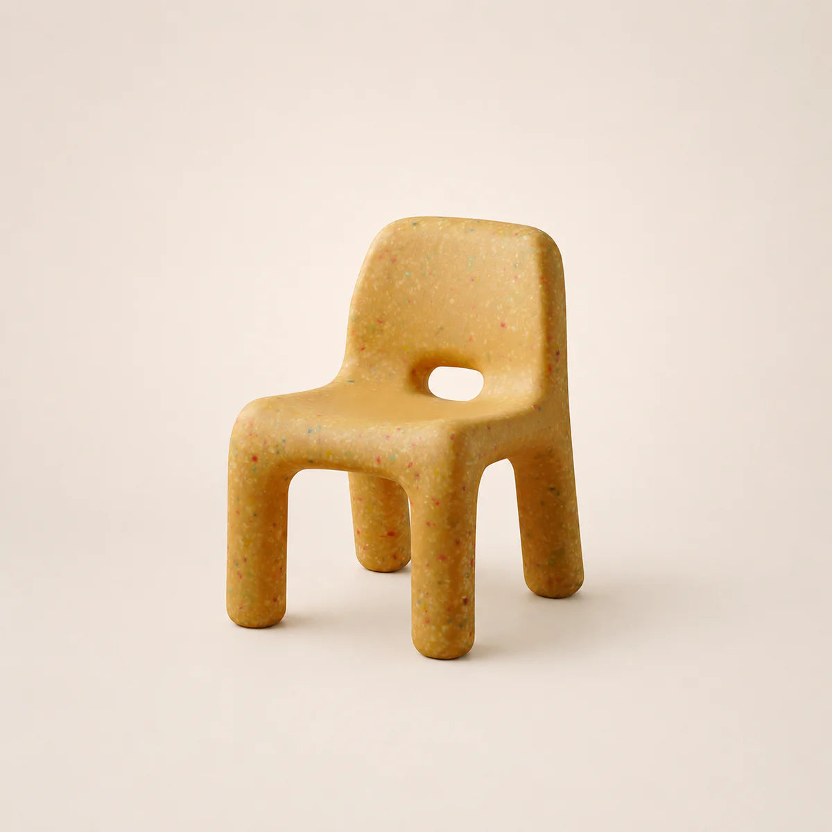 Yellow chair with a textured surface on a beige background