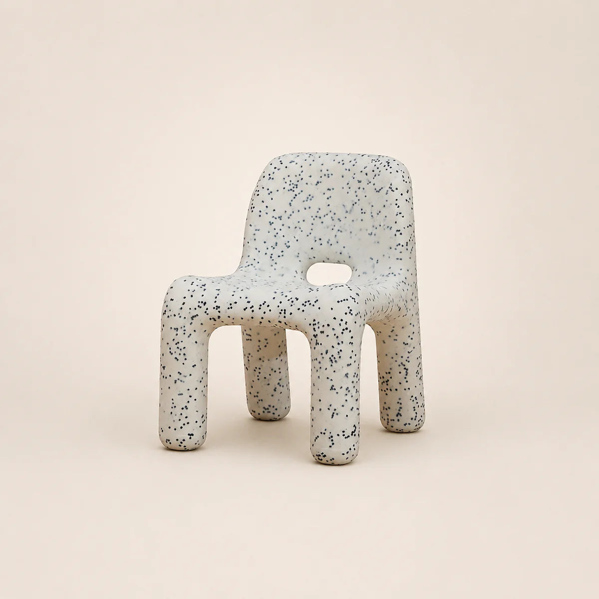 Speckled chair on a beige background