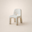 Speckled ceramic chair on a beige background