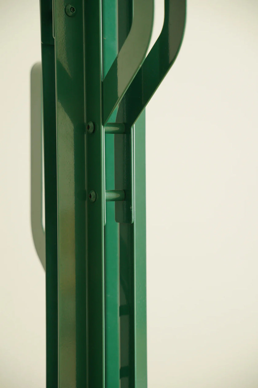 Green coat rack stand metal frame against a white background