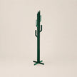 Green cactus-shaped coat rack on a beige background