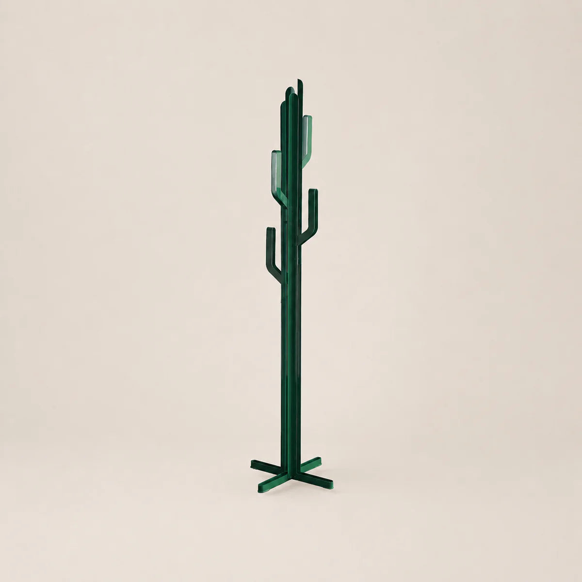 Green cactus-shaped coat rack on a beige background