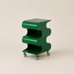 Green wavy side table on wheels against a beige background
