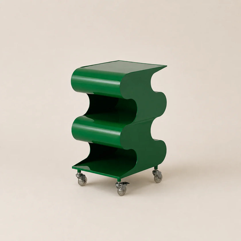 Green wavy side table on wheels against a beige background