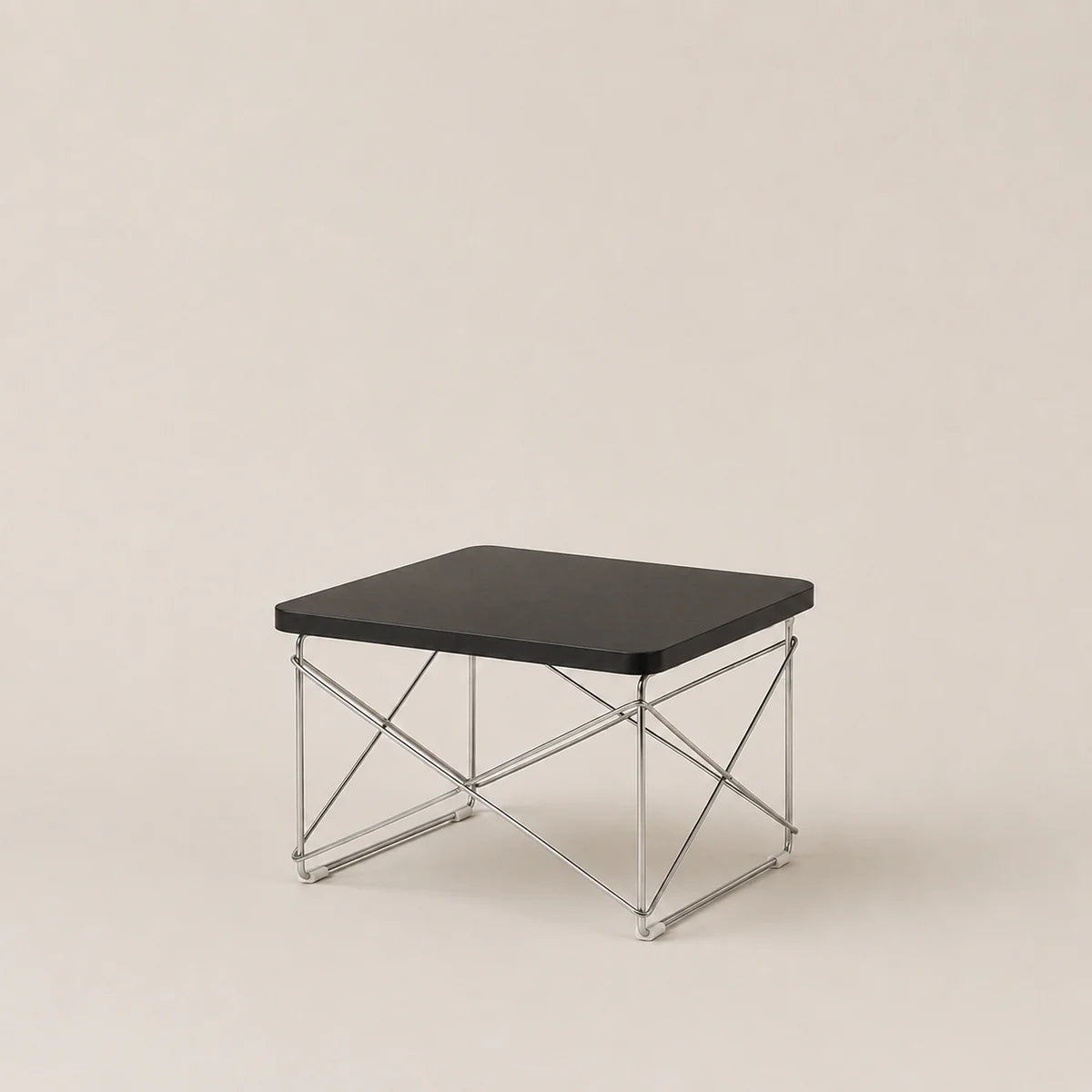 Small black table with metal frame on a beige background