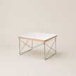 Coffee table with a white top and metal frame on a beige background
