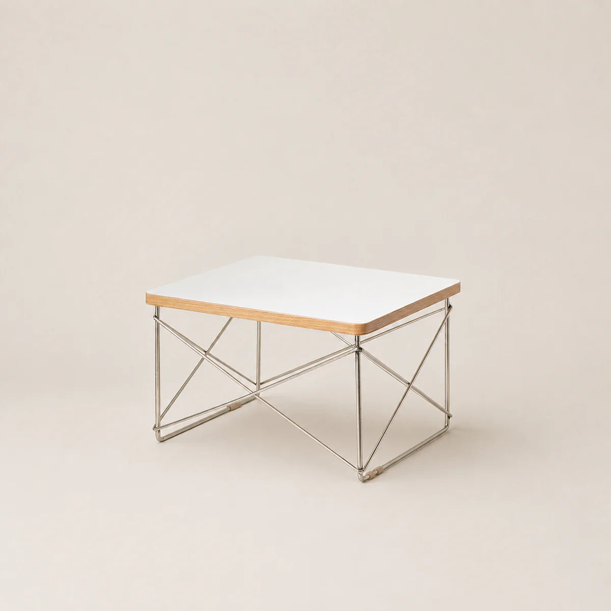 Coffee table with a white top and metal frame on a beige background