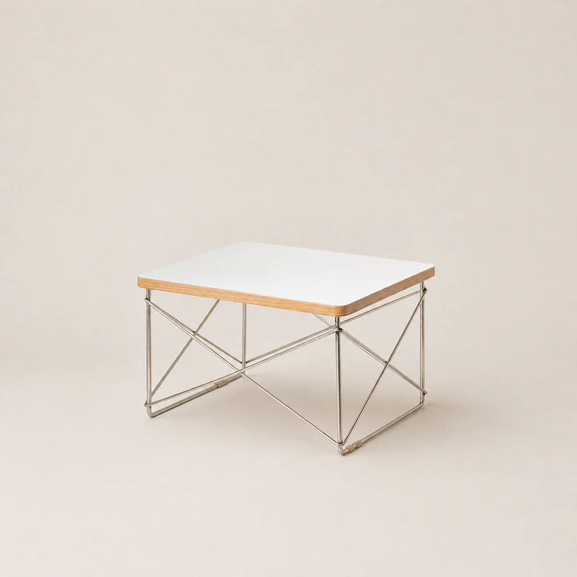 Coffee table with a white top and metal frame on a beige background
