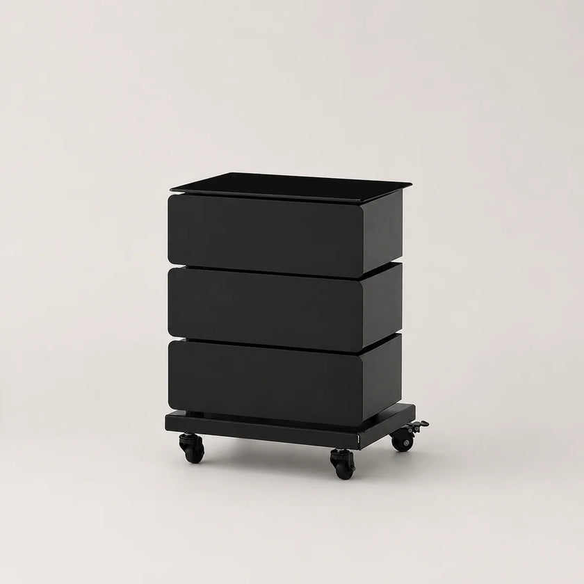 A black three-drawer storage cart with a rectangular top and four caster wheels, photographed on a clean light gray studio background.