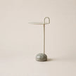Small side table with marble base on a beige background