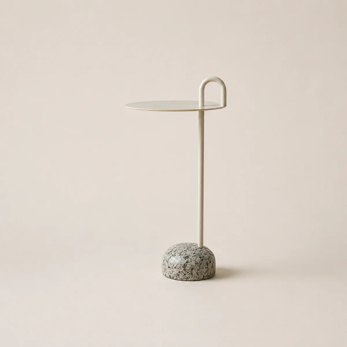Small side table with marble base on a beige background