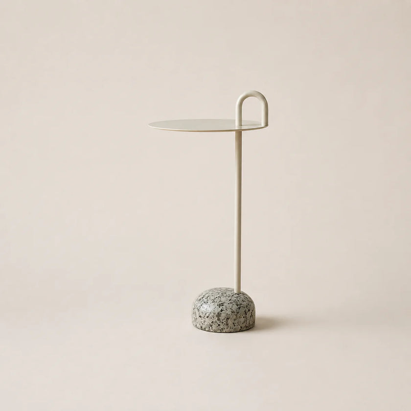 Small side table with marble base on a beige background