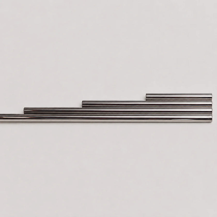 Four metallic silver rods of varying lengths arranged in a stepped horizontal layout against a plain light gray background.