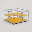 A modular cube storage organizer with a chrome metal frame, clear glass panels on the top, and mustard yellow shelves on the bottom, shown on a light gray background.