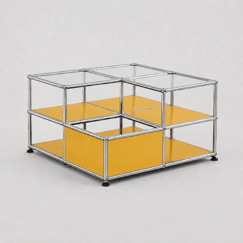 A modular cube storage organizer with a chrome metal frame, clear glass panels on the top, and mustard yellow shelves on the bottom, shown on a light gray background.