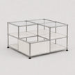 A modular storage organizer made of clear acrylic panels and silver metal tubing with black feet, shown on a light gray background.