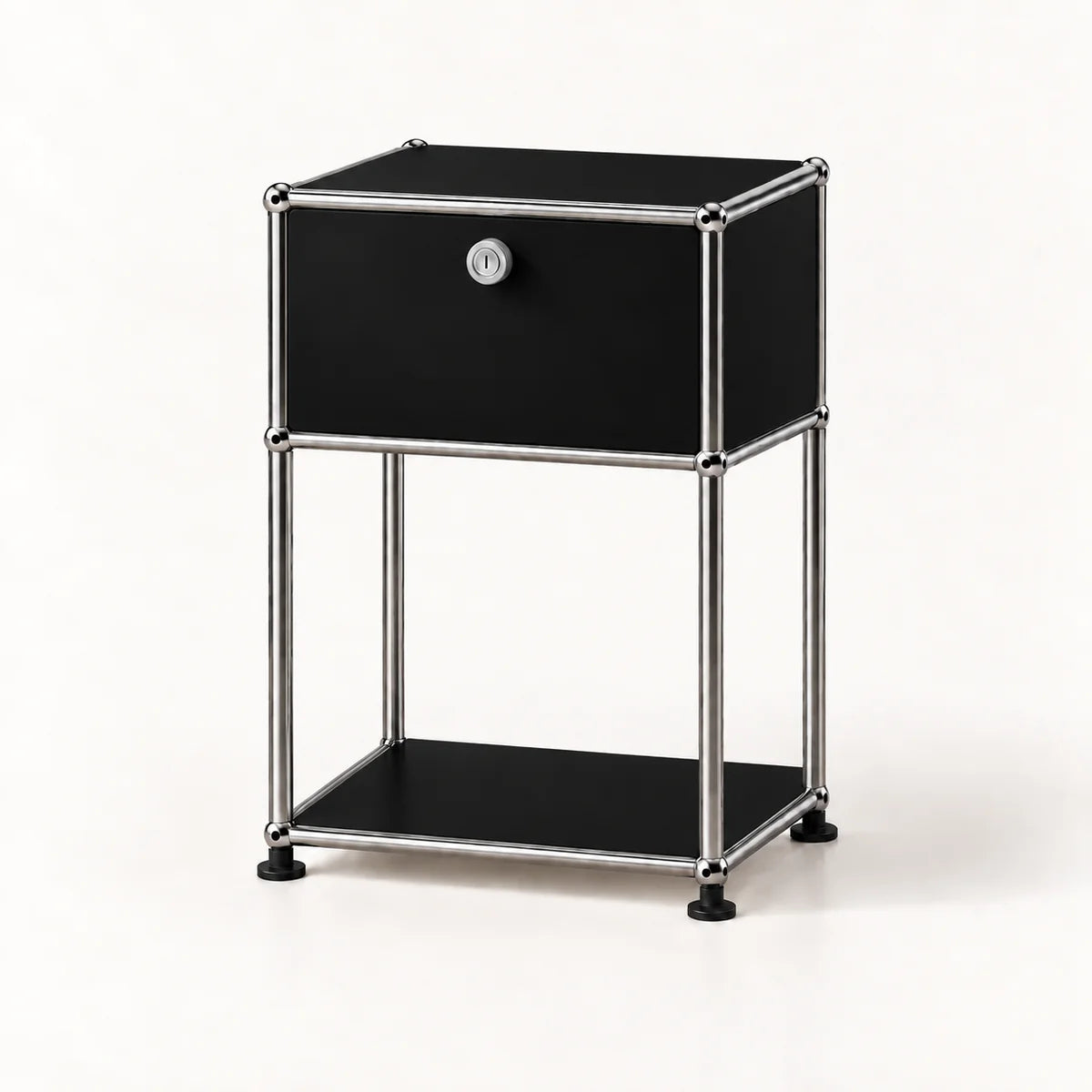 A modern black and chrome storage cabinet with a single drawer, a lock, and an open lower shelf, set against a plain white background.