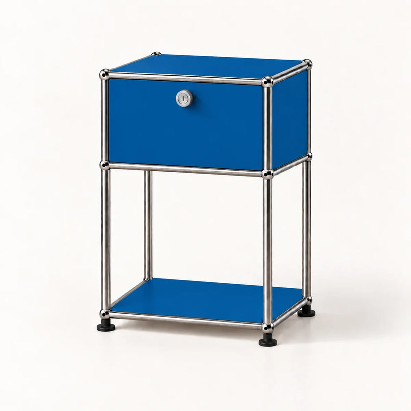 A modern two-tier nightstand with a cobalt blue drawer and shelves, supported by a chrome tubular metal frame with black rubber feet, shown on a clean white background.