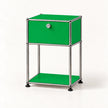 A modern two-tier storage cabinet with a bright green enamel finish and a chrome tubular steel frame, featuring a single lockable drawer on the top shelf and an open lower shelf.