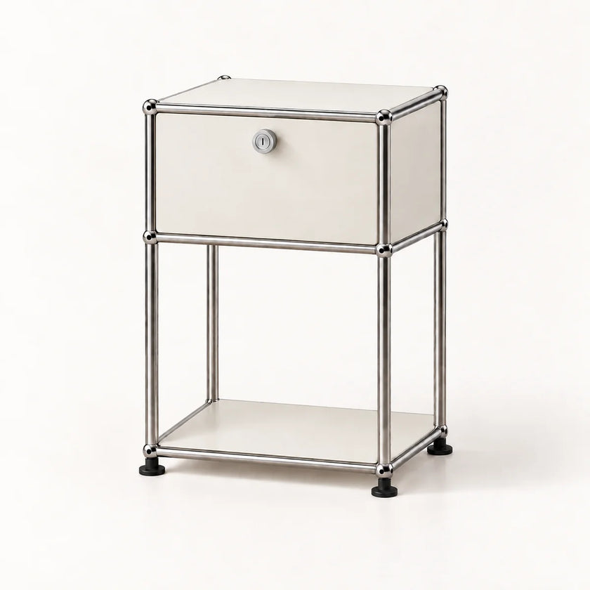 A modern two-tier nightstand featuring a silver chrome tubular metal frame, cream-colored panels, and a single lockable drawer on the top tier with a round silver knob.
