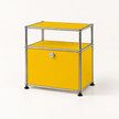 A modern modular storage cabinet with a golden yellow enamel body, a chrome tubular steel frame, and a lockable front door, set against a clean white background.