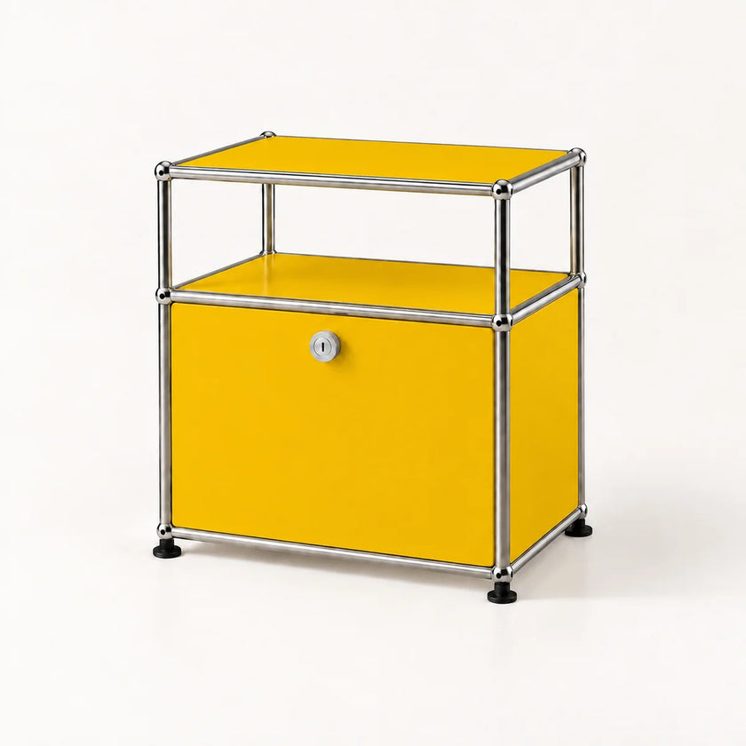 A modern modular storage cabinet with a golden yellow enamel body, a chrome tubular steel frame, and a lockable front door, set against a clean white background.