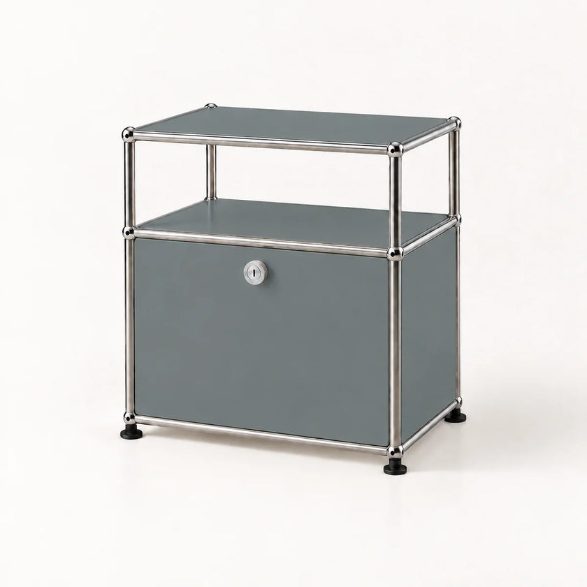 A modern two-tier storage cabinet with a gray faux-leather finish and a chrome tubular metal frame, featuring a single lockable door with a silver keyhole and black rubber feet.