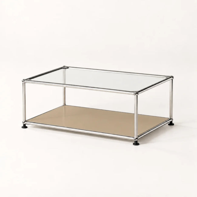 A modern two-tier coffee table with a chrome metal frame, a clear glass top, and a beige lower shelf, shown on a clean white background.
