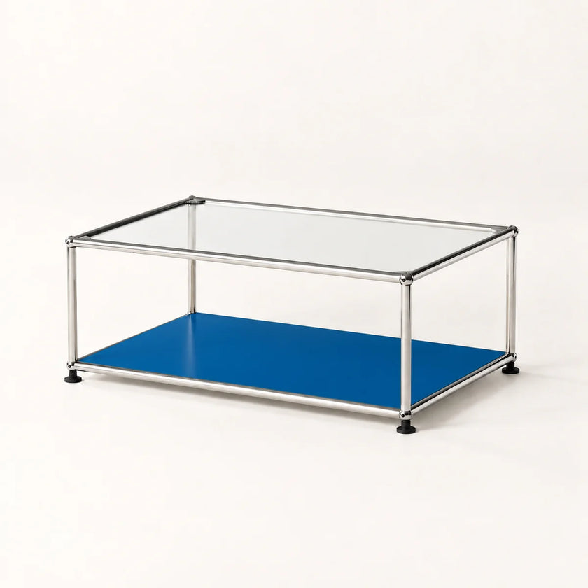 A modern two-tier coffee table with a clear glass top, a stainless metal frame, and a vibrant blue lower shelf, shown on a clean white background.