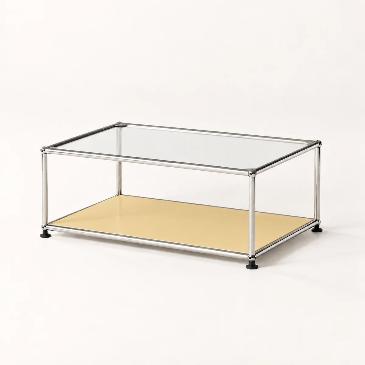 A modern two-tier coffee table with a clear glass top, a metallic stainless frame, and a light beige lower shelf, shown on a plain white background.