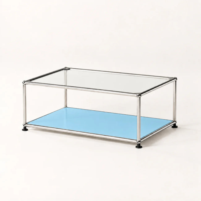 A modern two-tier coffee table with a chrome metal frame, a clear glass top, and a light blue metal lower shelf, shown on a plain off-white background.