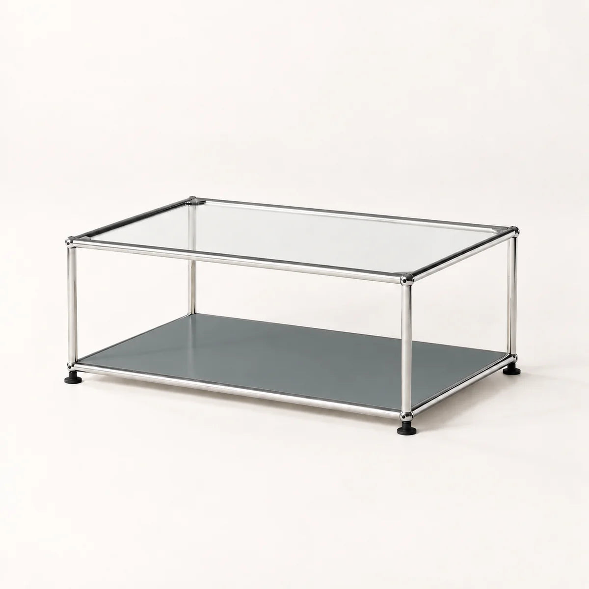 A modern two-tier coffee table with a clear glass top, a dark gray lower shelf, and a stainless chrome metal frame with black feet, shown on a clean white background.