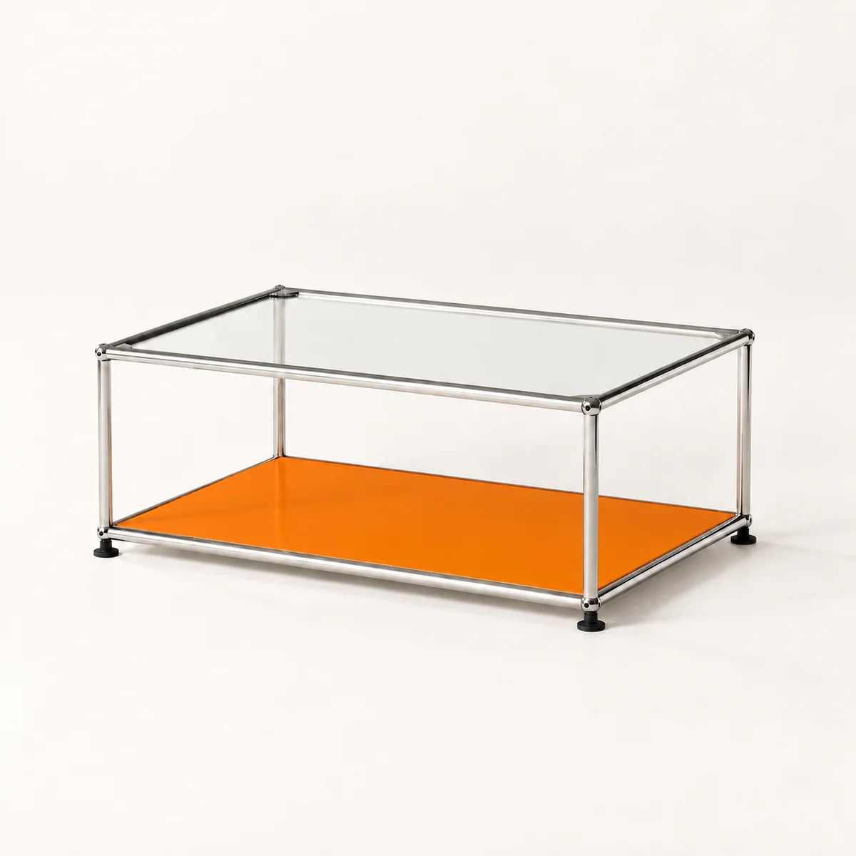 A modern rectangular coffee table with a clear glass top, a bright orange lower shelf, and a slim stainless metal frame with black feet, shown on a clean white background.