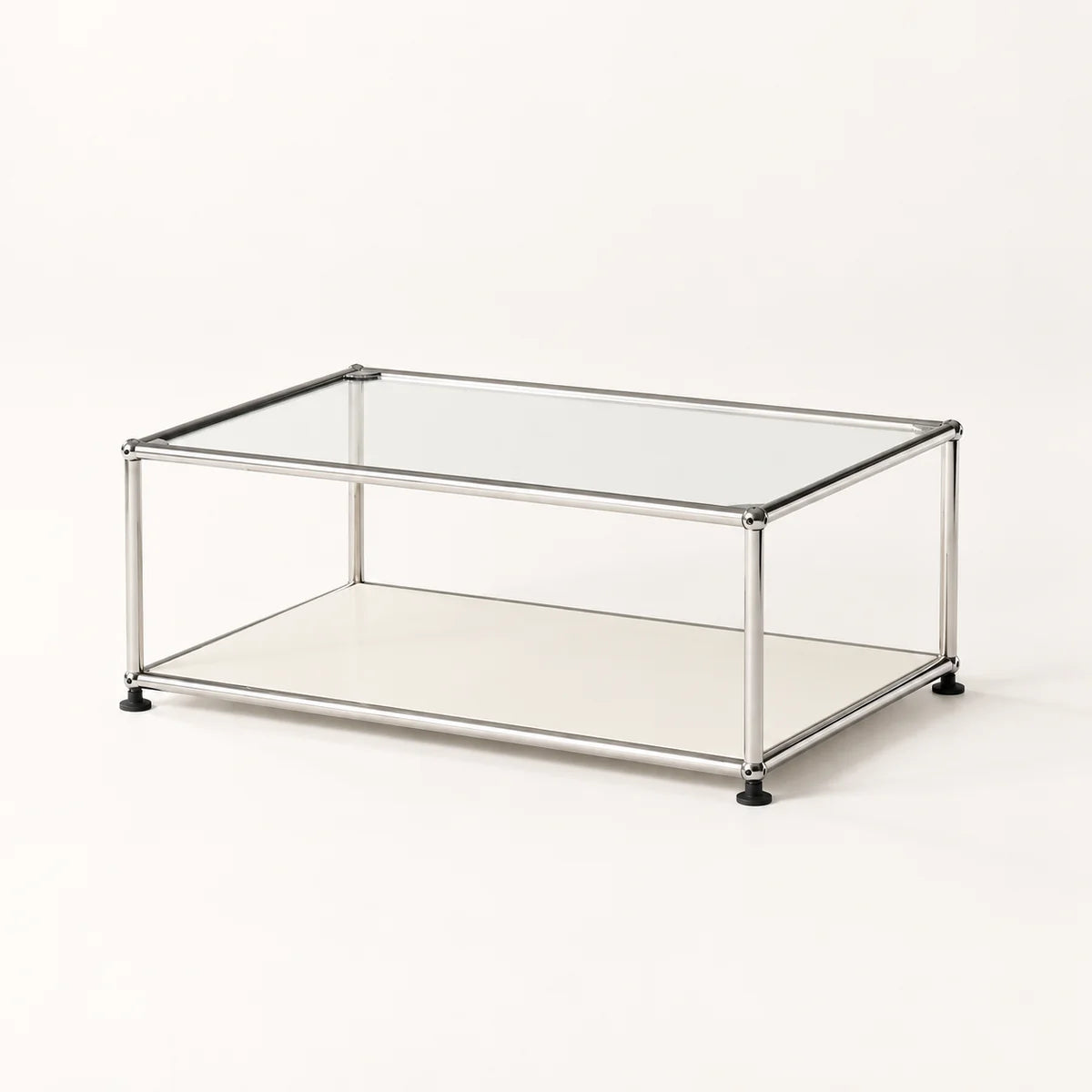 A modern rectangular coffee table with a clear glass top, a lower metal shelf, and a slim stainless metal frame with black feet, shown on a clean white background.