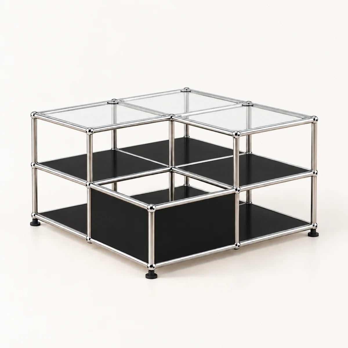 A modular two-tier storage organizer made of a chrome metal frame with black metal shelves and clear glass top panels, shown on a light cream background.