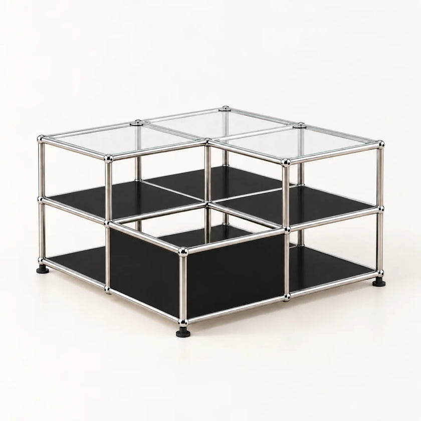 A modular two-tier storage organizer made of a chrome metal frame with black metal shelves and clear glass top panels, shown on a light cream background.