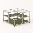 A modular two-tier storage organizer made of a chrome metal frame with olive green panels and clear glass top lids, shown on a light cream background.
