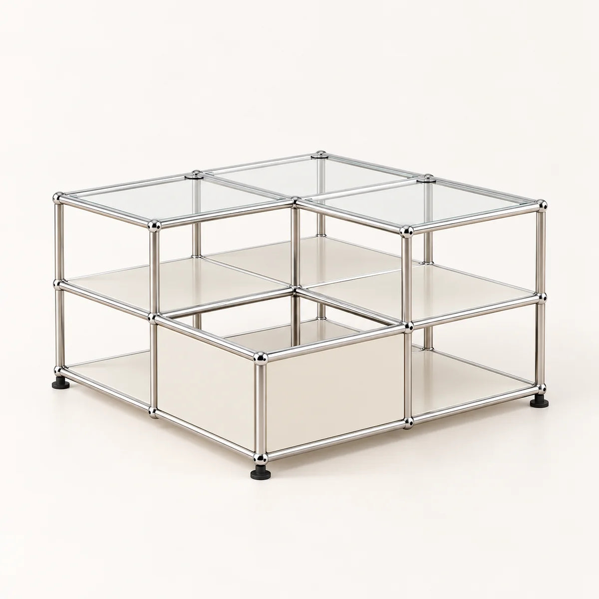 A modular metal and glass storage organizer with square compartments, featuring a stainless chrome frame, clear glass panels, and black rubber feet on a light beige background.