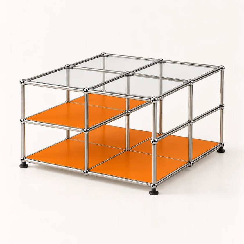 A modular metal storage organizer with a chrome-finished frame, clear glass panels on the top, and bright orange shelves on the bottom, shown on a clean white background.