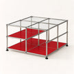 A modular storage organizer made of a chrome metal frame with clear glass panels on top and bright red shelves on the bottom, shown on a clean white background.