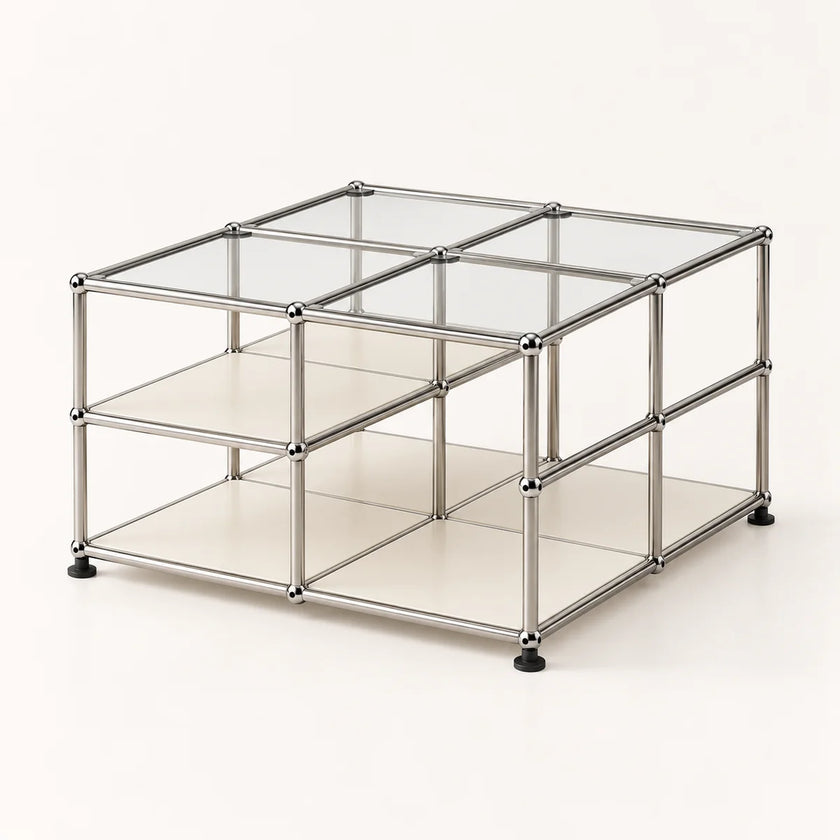 A modular storage organizer made of a chrome-finished metal frame with clear glass panels and cream-colored shelves, shown on a light beige background.